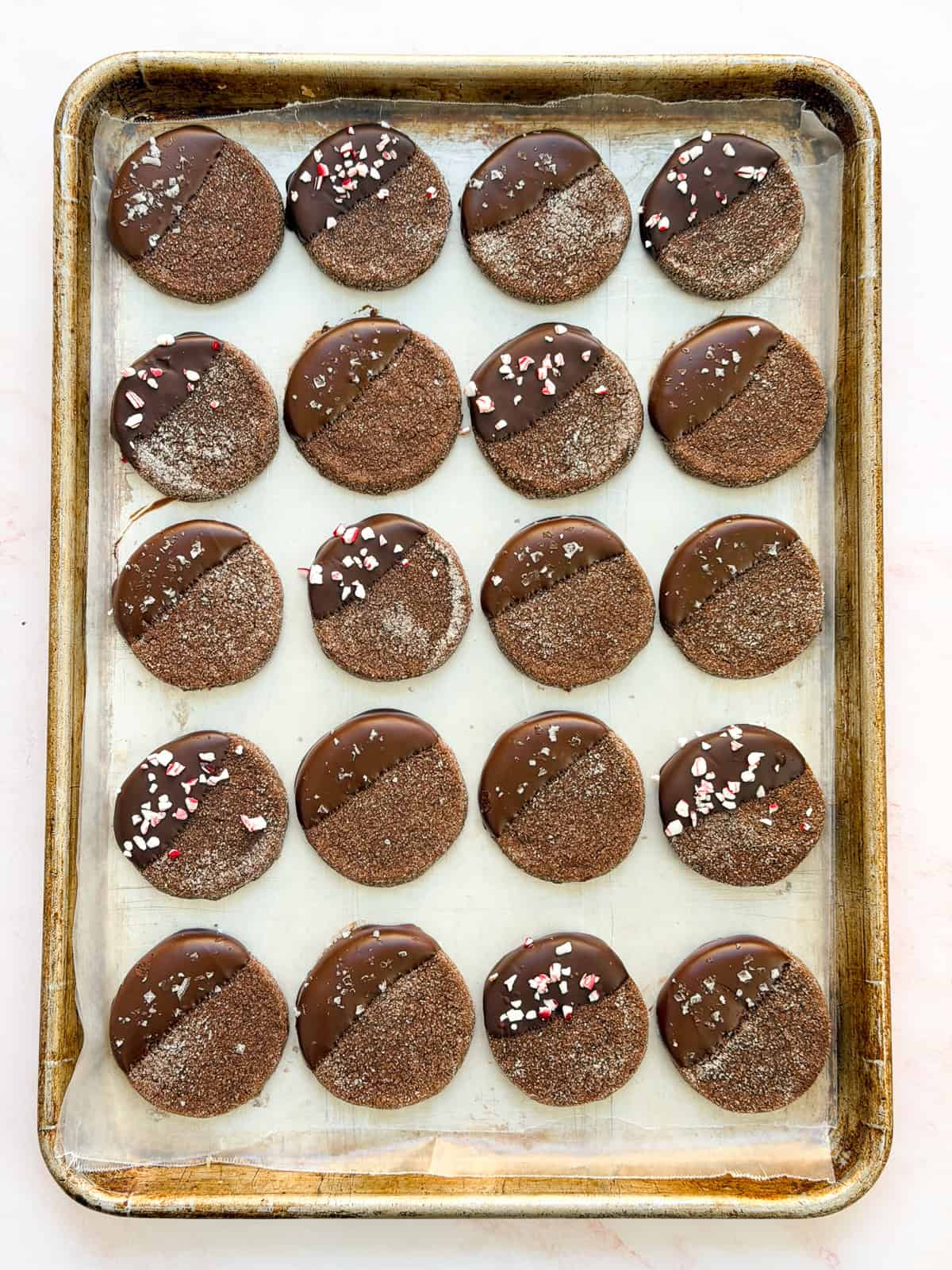 a full sheet pan of chocolate shortbread cookies with salt or peppermint on top.