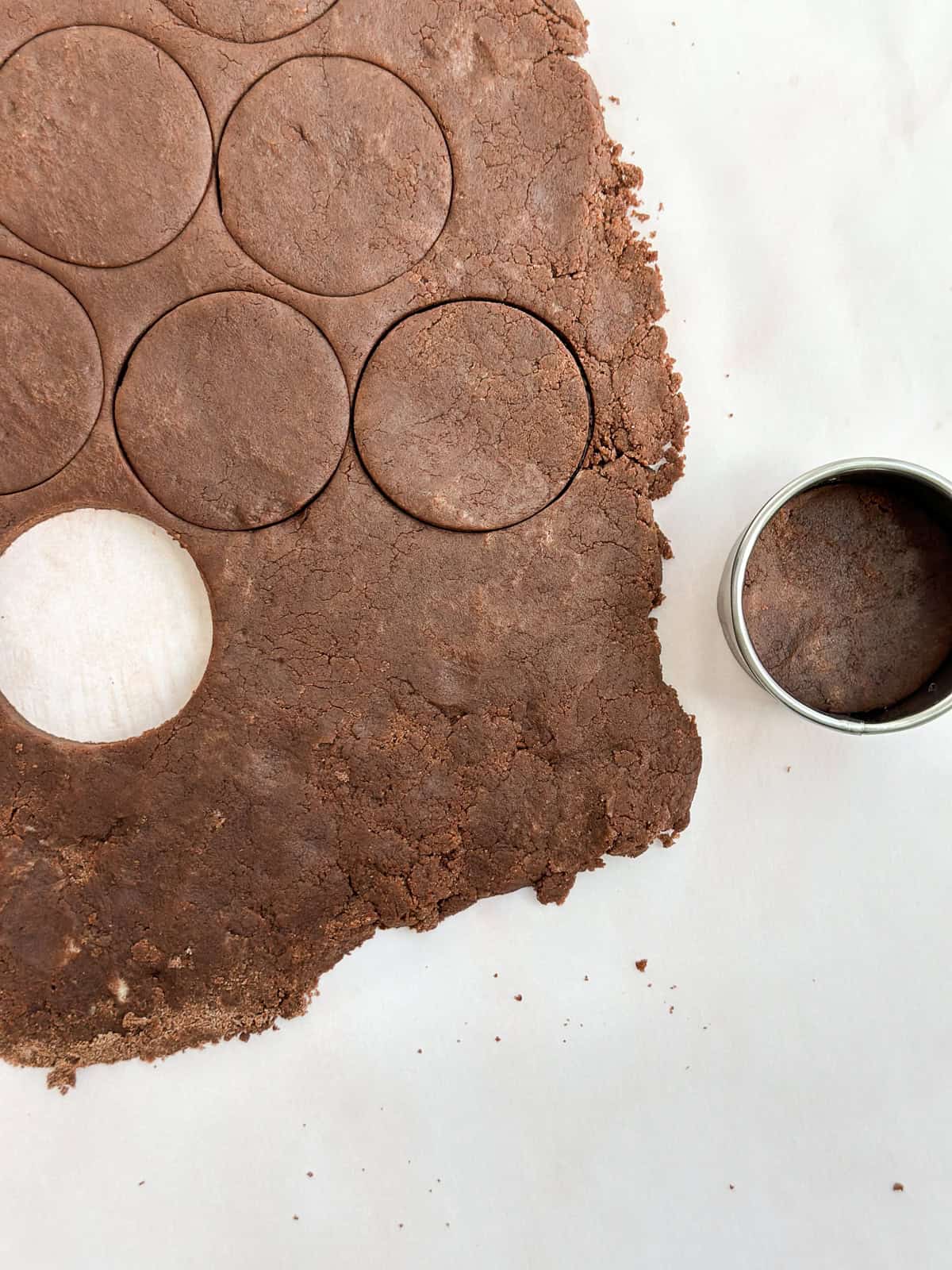 cookie dough being rolled out and cut.