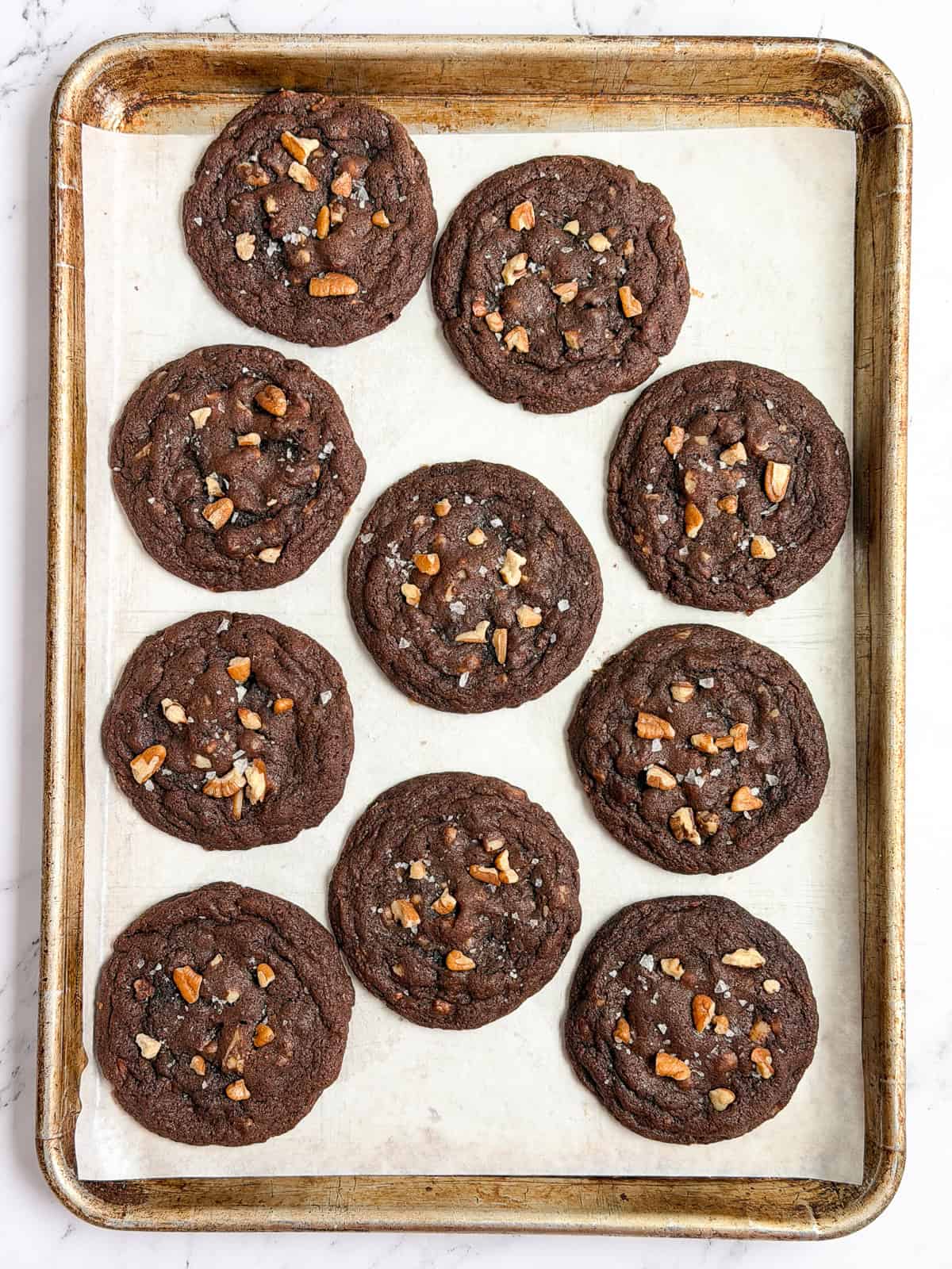 a full sheet pan of chocolate turtle cookies.