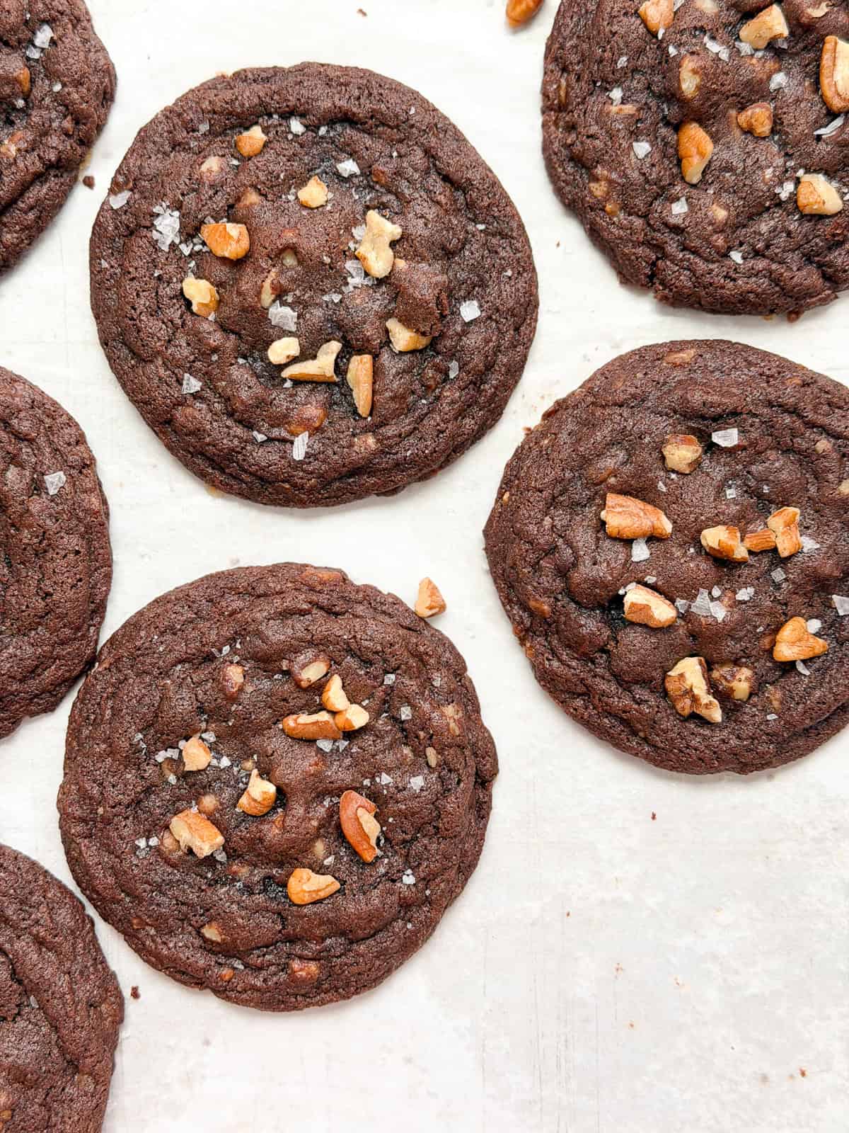 a close up of some chocolate turtle cookies.