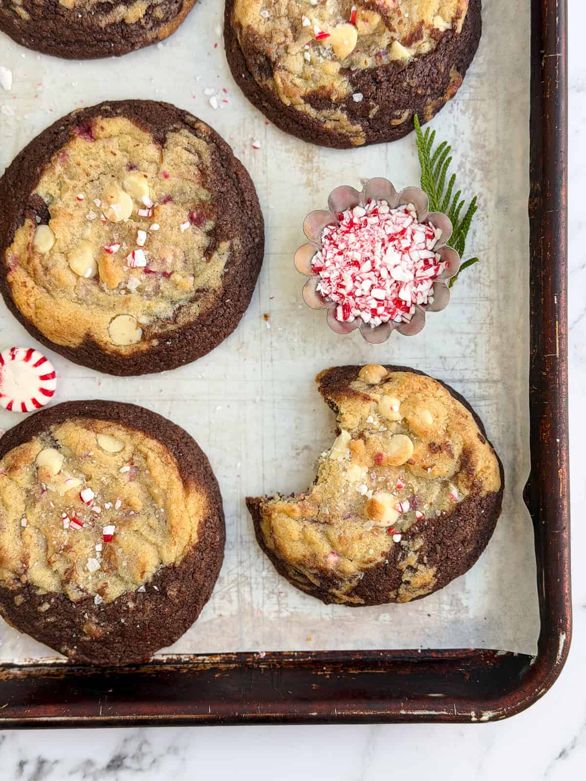 a peppermint white chocolate brookies cookie with a big bite missing.