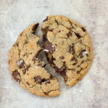 a single serve chocolate chip cookie broken in half.