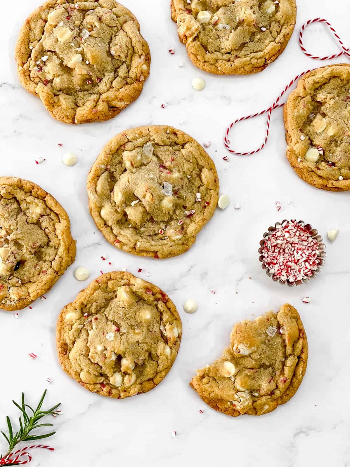 white chocolate peppermint pretzel cookies with one broken in half.