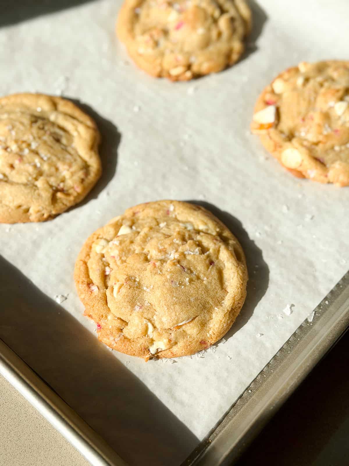 some of the white chocolate peppermint pretzel cookies on a baking sheet.