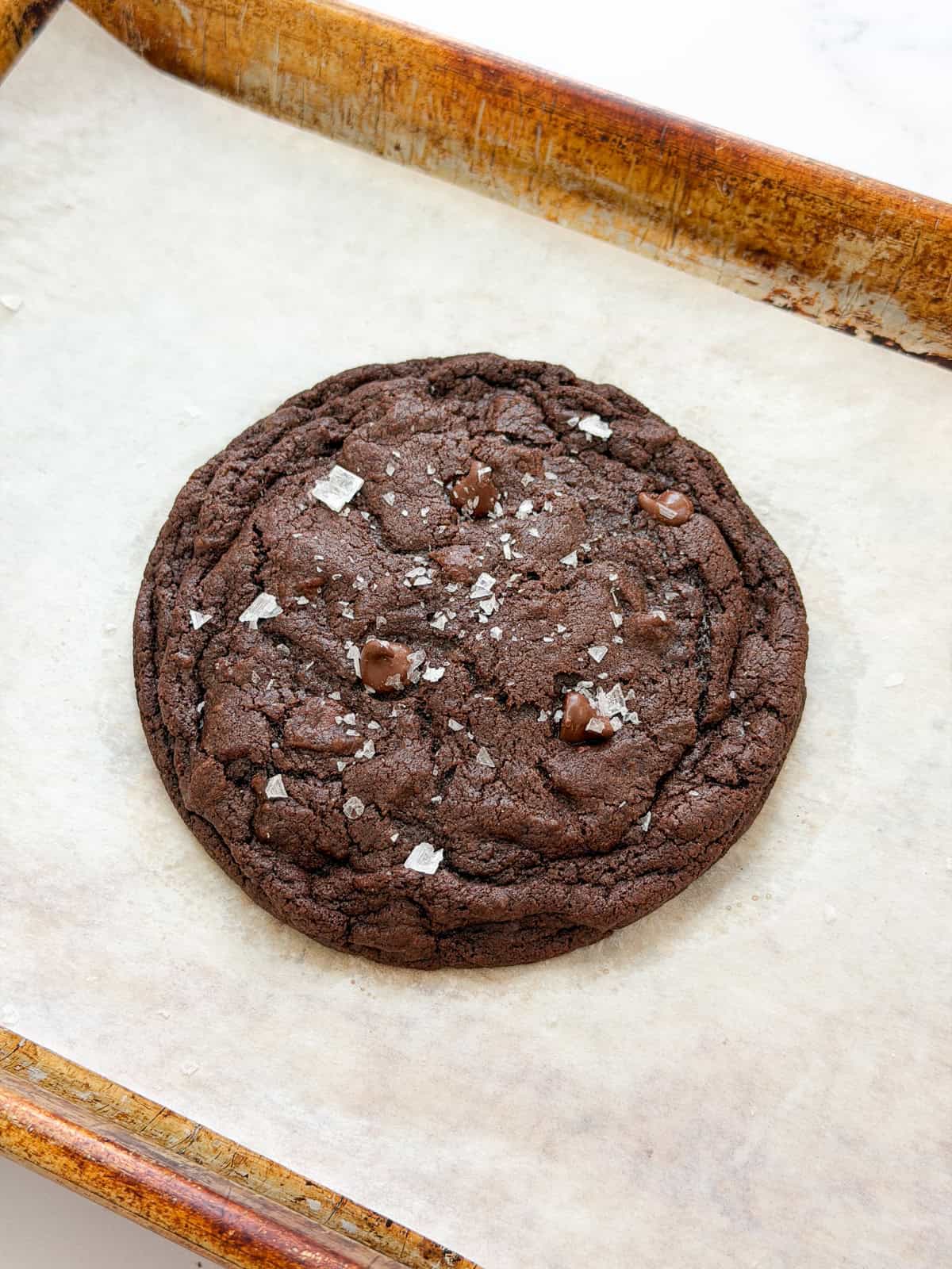 a single serve chocolate cookie on a baking sheet.