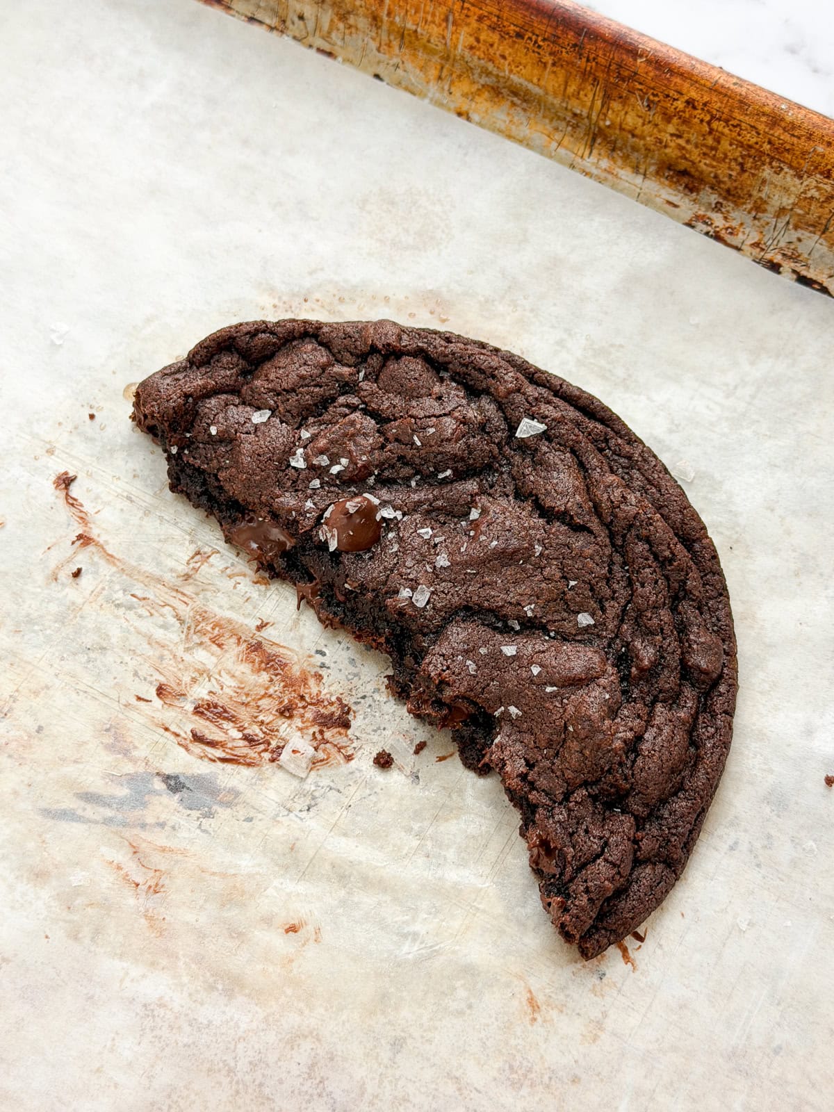a side view of a piece of cookie so you can see the melty chocolate inside.