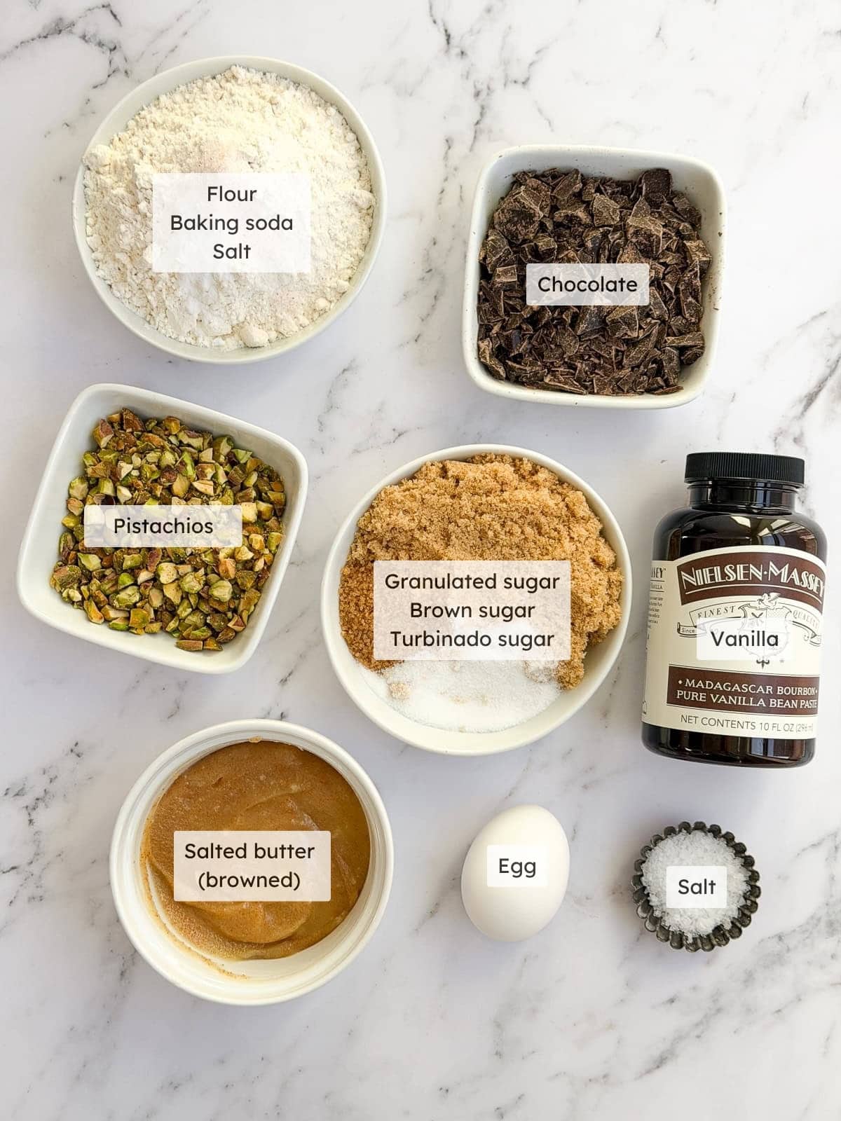 All of the ingredients needed to make pistachio chocolate chip cookies.