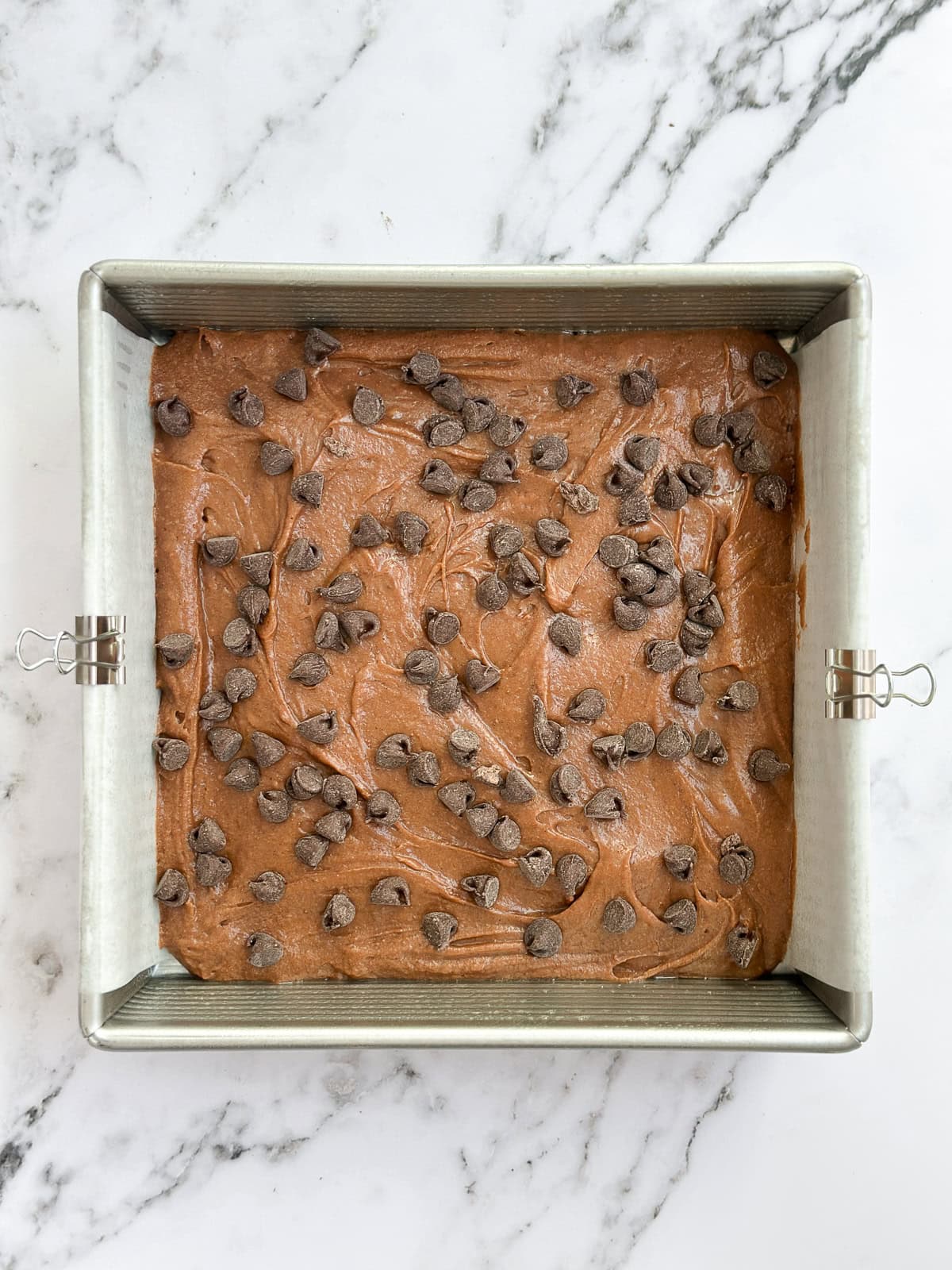 brownie batter added and chocolate chips topped.