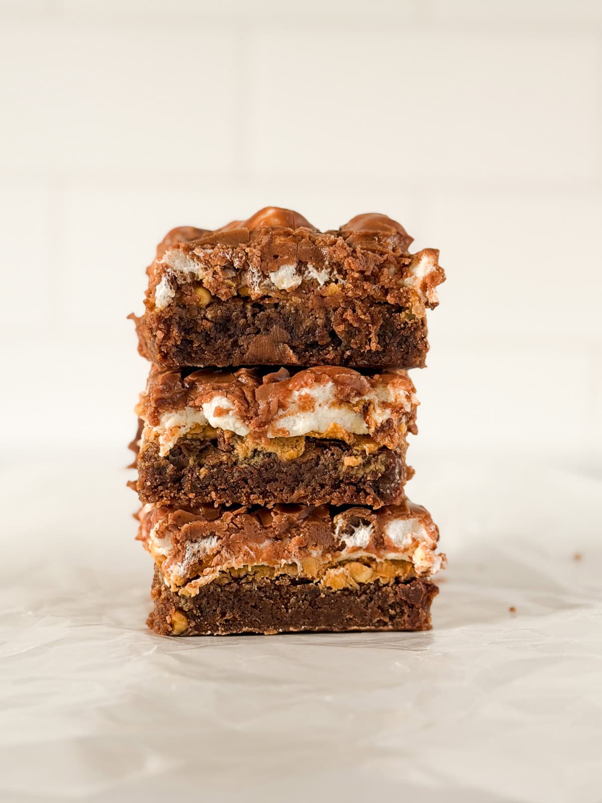 a few peanut butter marshmallow brownies stacked on top of each other.