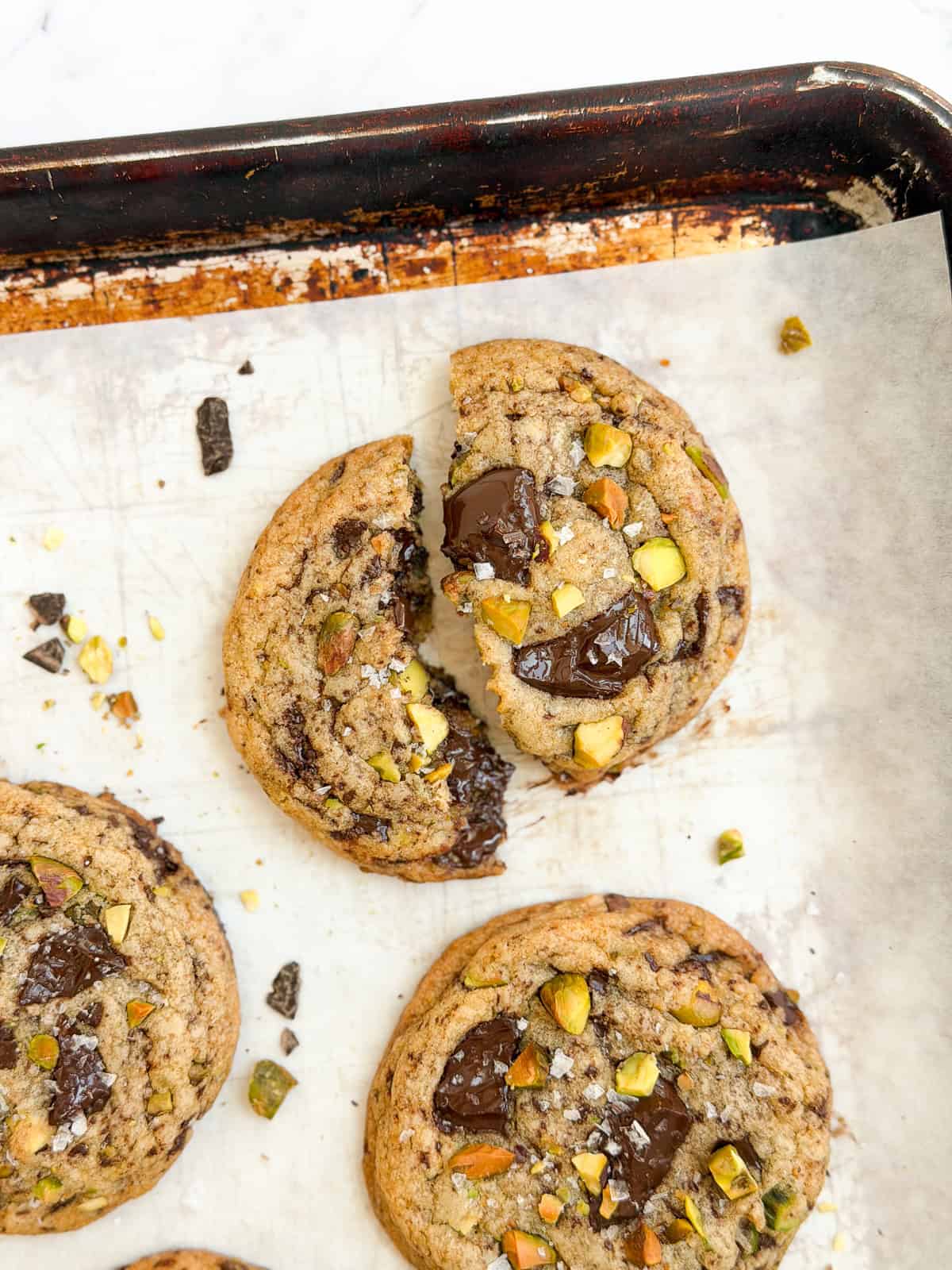 a broken cookie showing the melty chocolate.