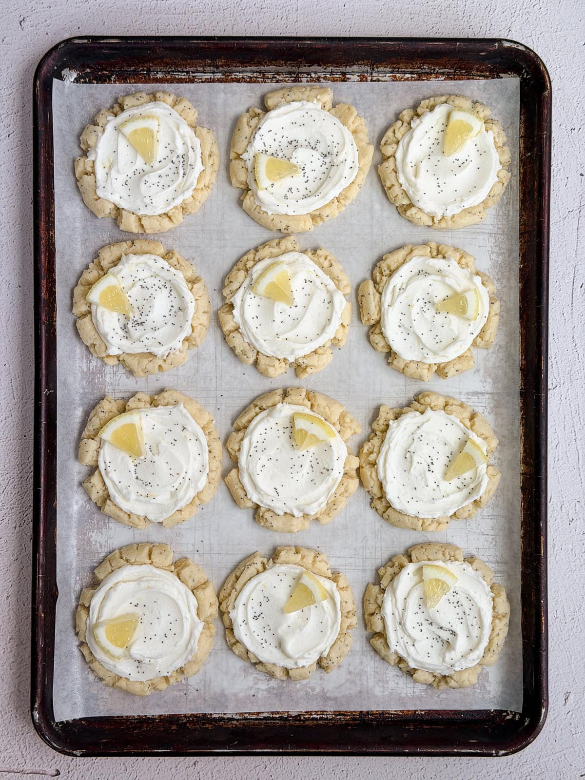 a full cookie sheet of lemon poppyseed cookies all finished.