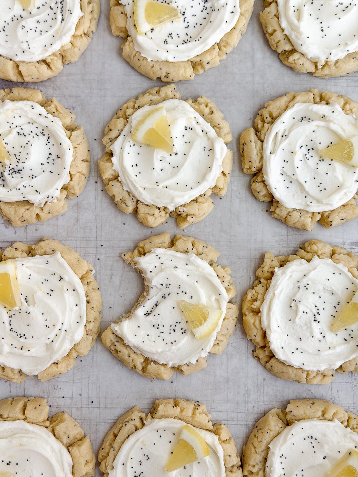 lemon poppyseed cookies with a bite missing from one.