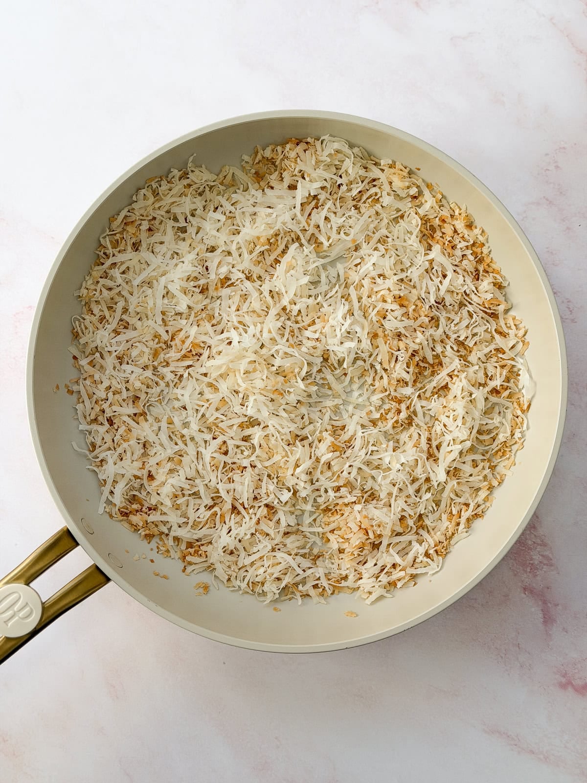 toasted coconut in a frying pan.