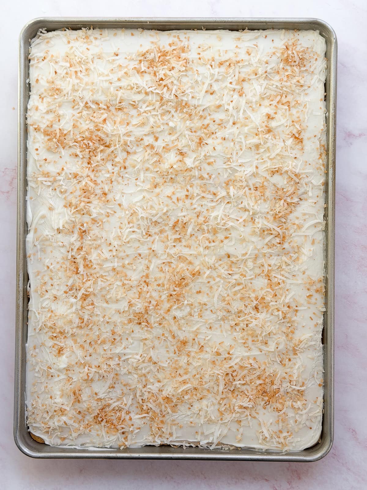 glaze and toasted coconut on top of cake.