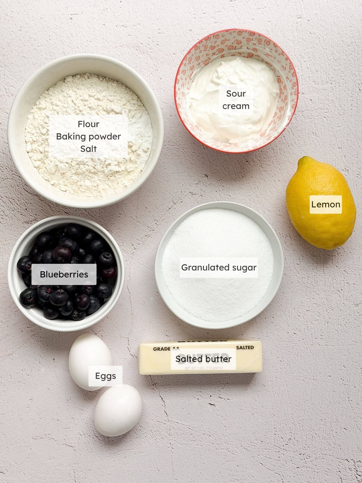 All of the ingredients needed to make lemon blueberry sour cream cake.