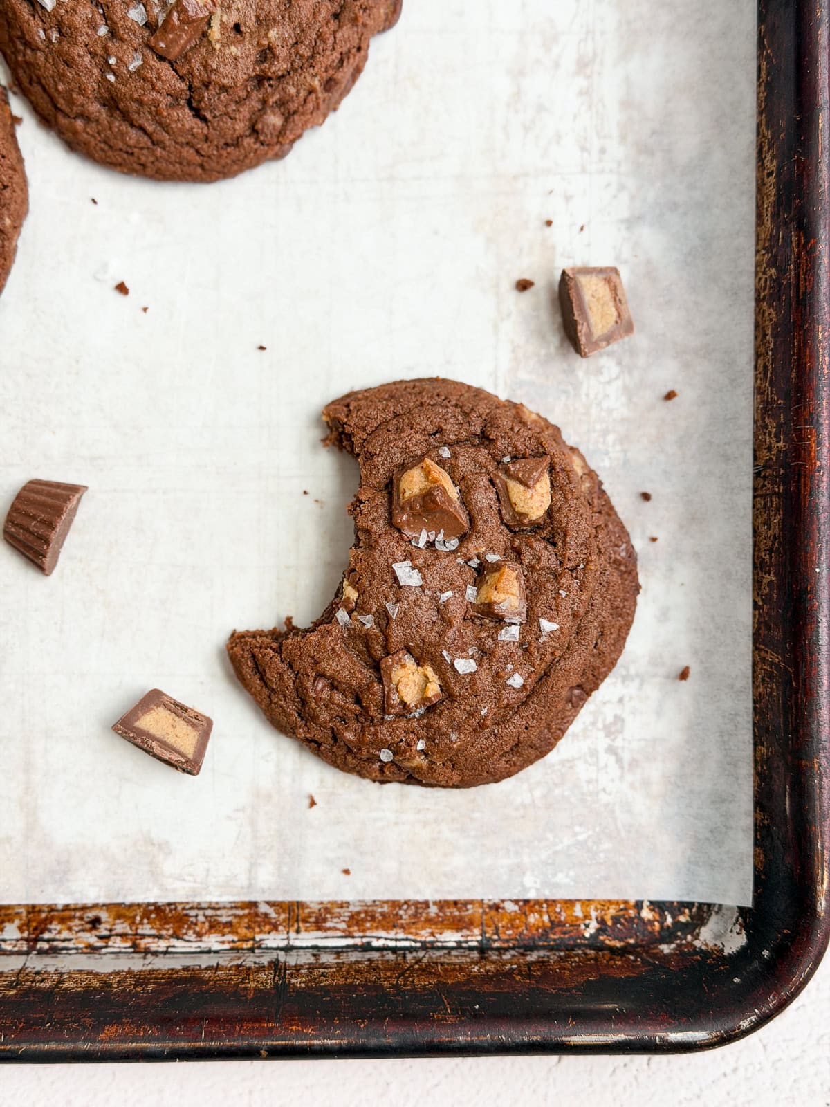 a chocolate peanut butter cup cookie with a bite missing,