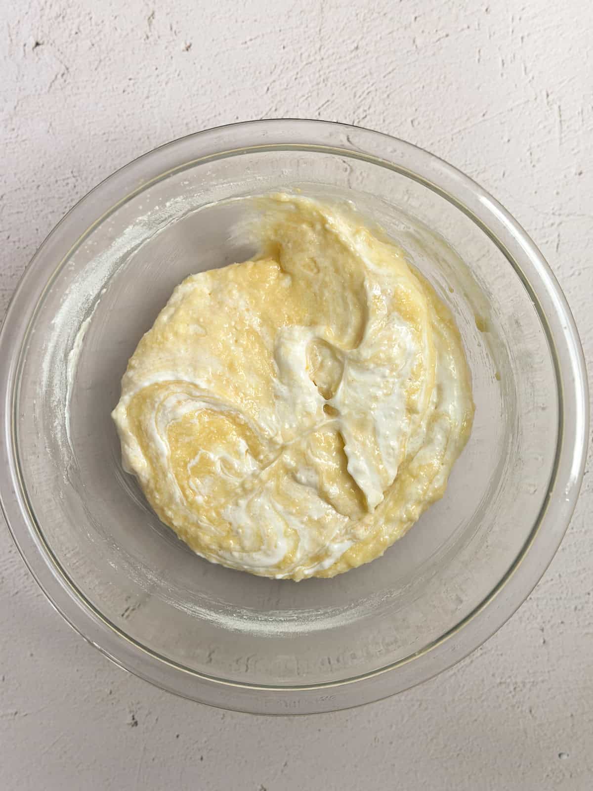 adding in the dry ingredients and sour cream.