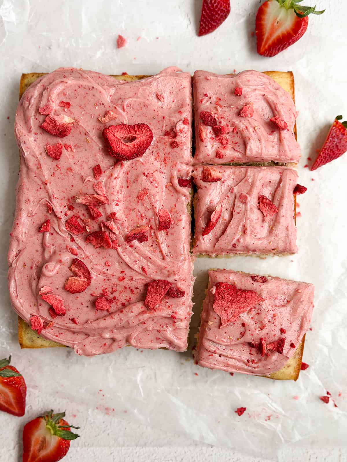 the strawberry snack cake after its frosted and topped with extra strawberries.