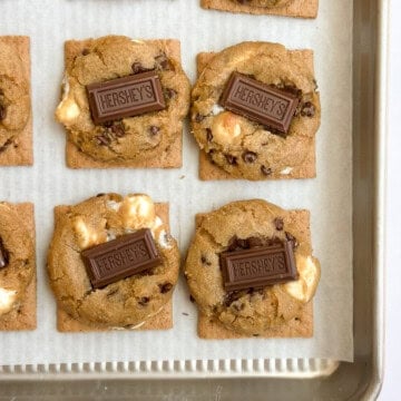 some of the graham cracker smore cookies on a baking sheet.
