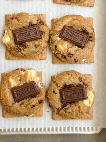 some of the graham cracker smore cookies on a baking sheet.