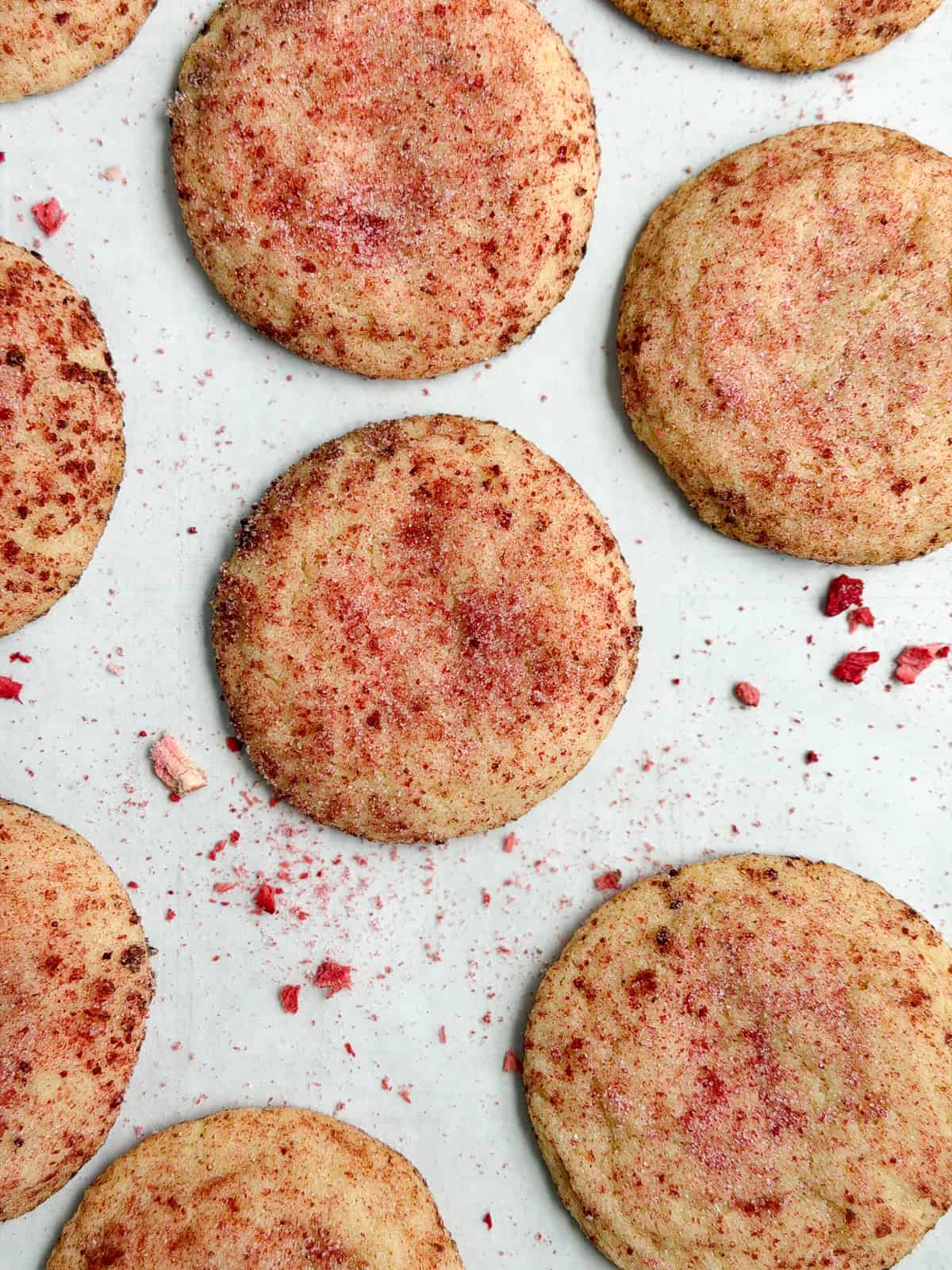 strawberry doodle cookies on a cookie sheet.