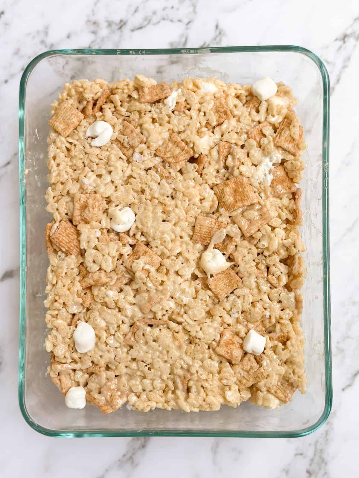 the cinnamon toast crunch marshmallow treats in a pan before serving.
