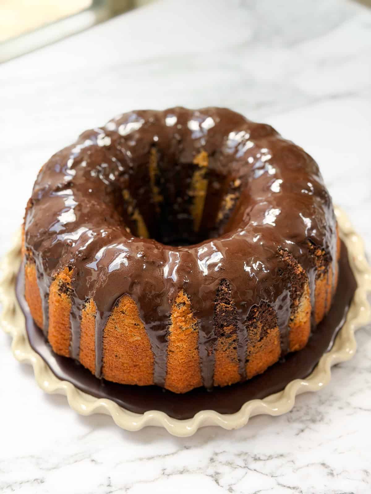 the whole marble bundt cake after adding a chocolate glaze.