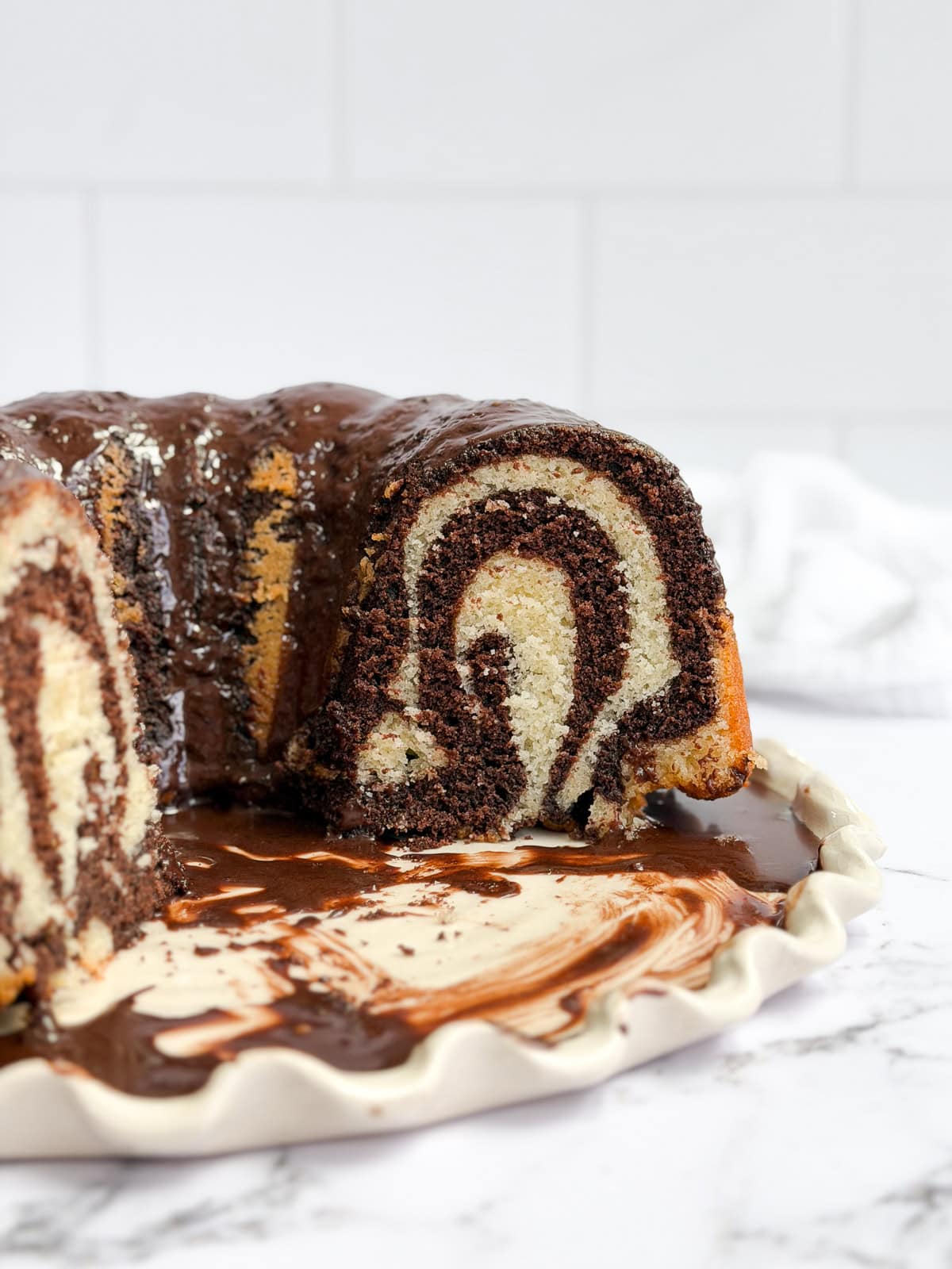 a side view of the marble bundt cake cut so you can see inside.