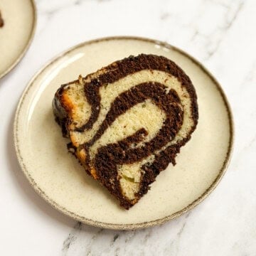 a single slice of marble bundt cake on a plate so you can see all the marbling.