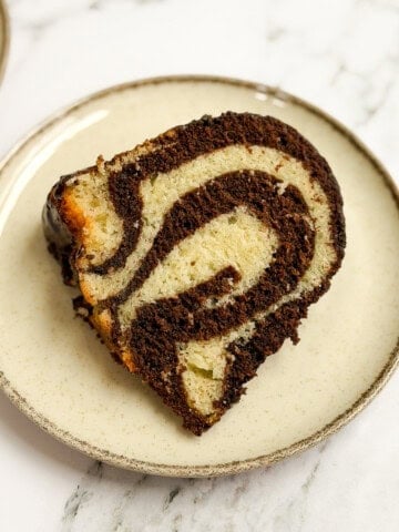 a single slice of marble bundt cake on a plate so you can see all the marbling.