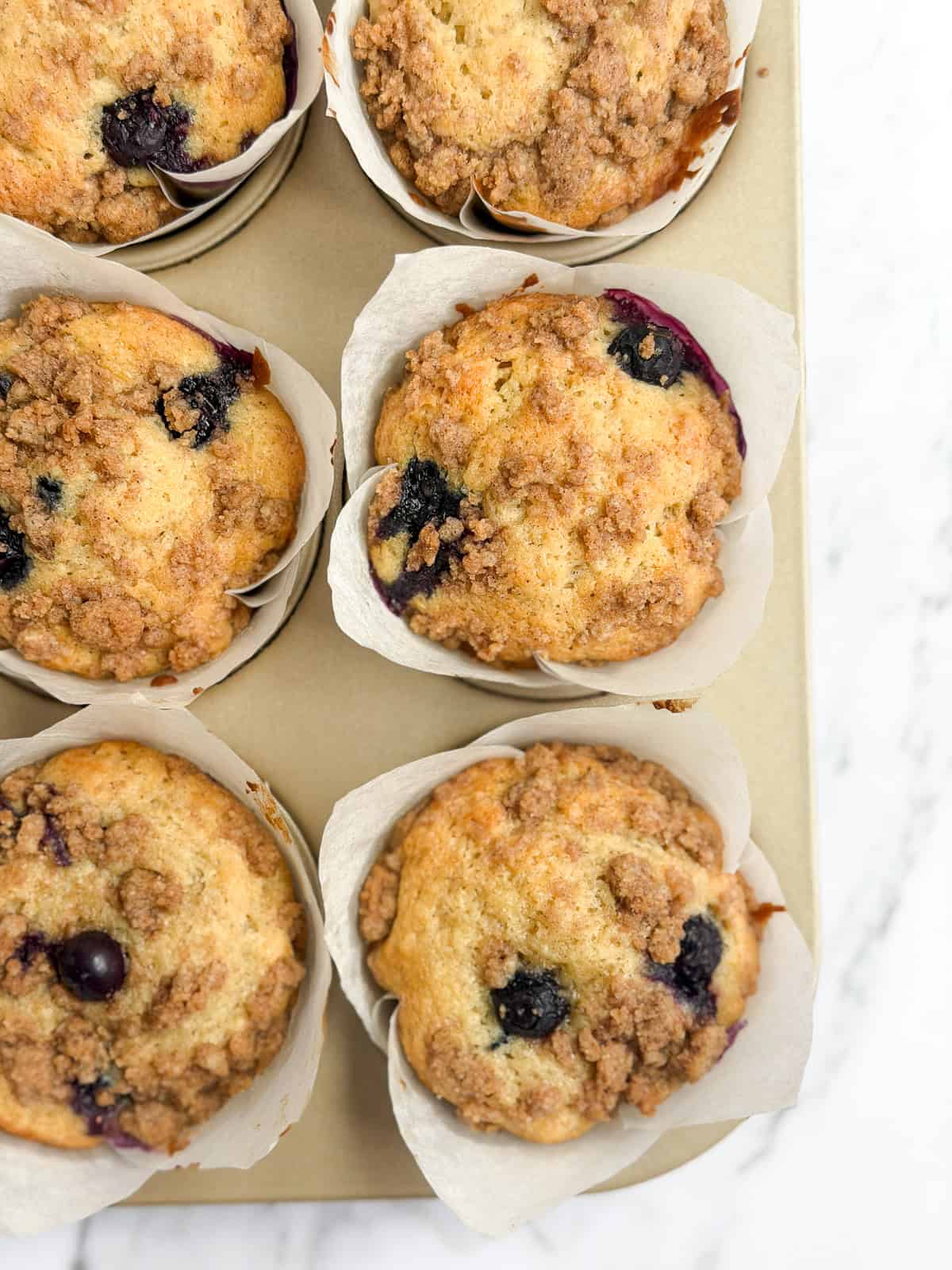 a closeup of a few blueberry peach muffins.