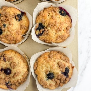 a closeup of a few blueberry peach muffins.