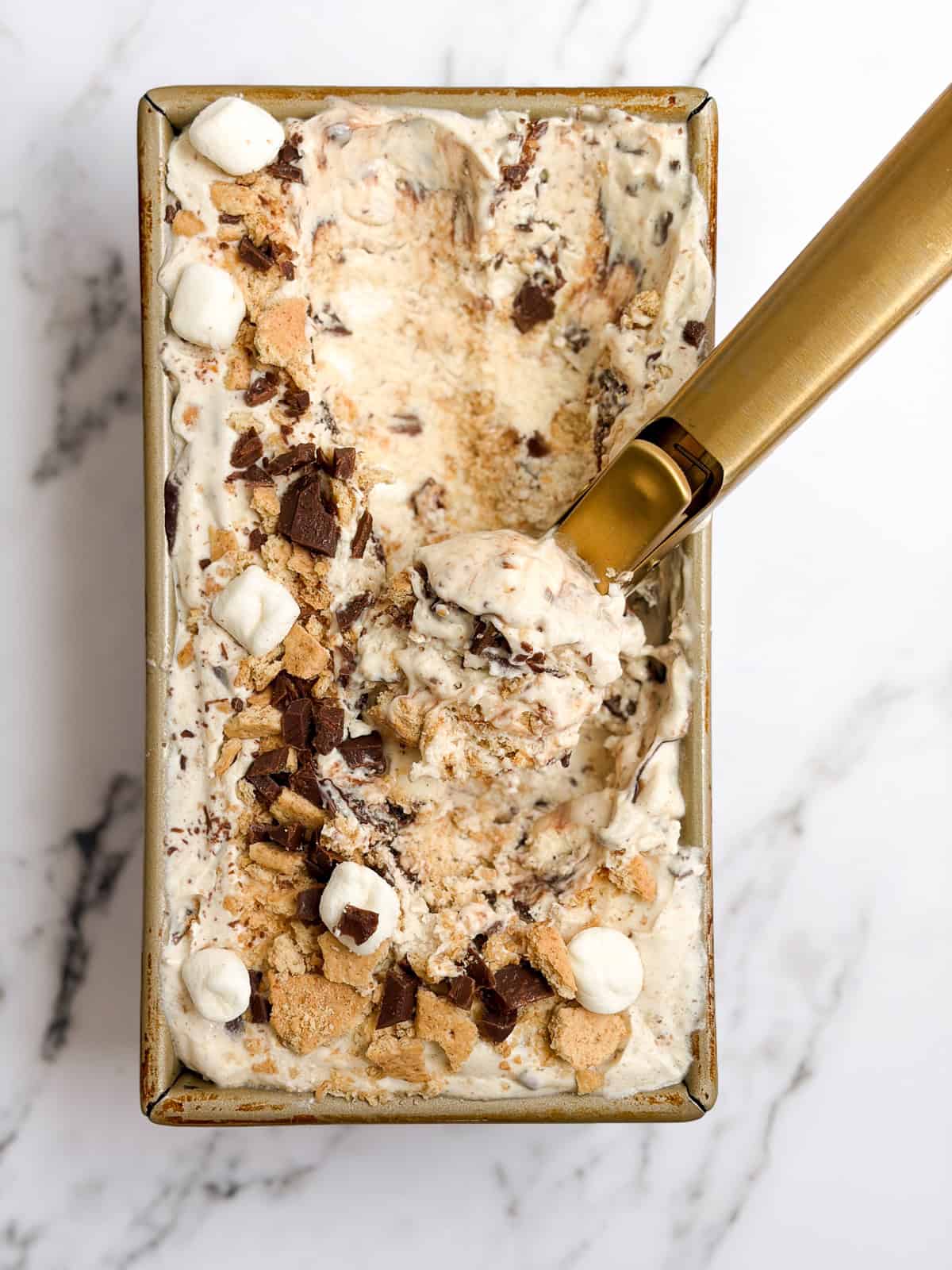 an ice cream scoop scooping out some homemade s'mores ice cream.