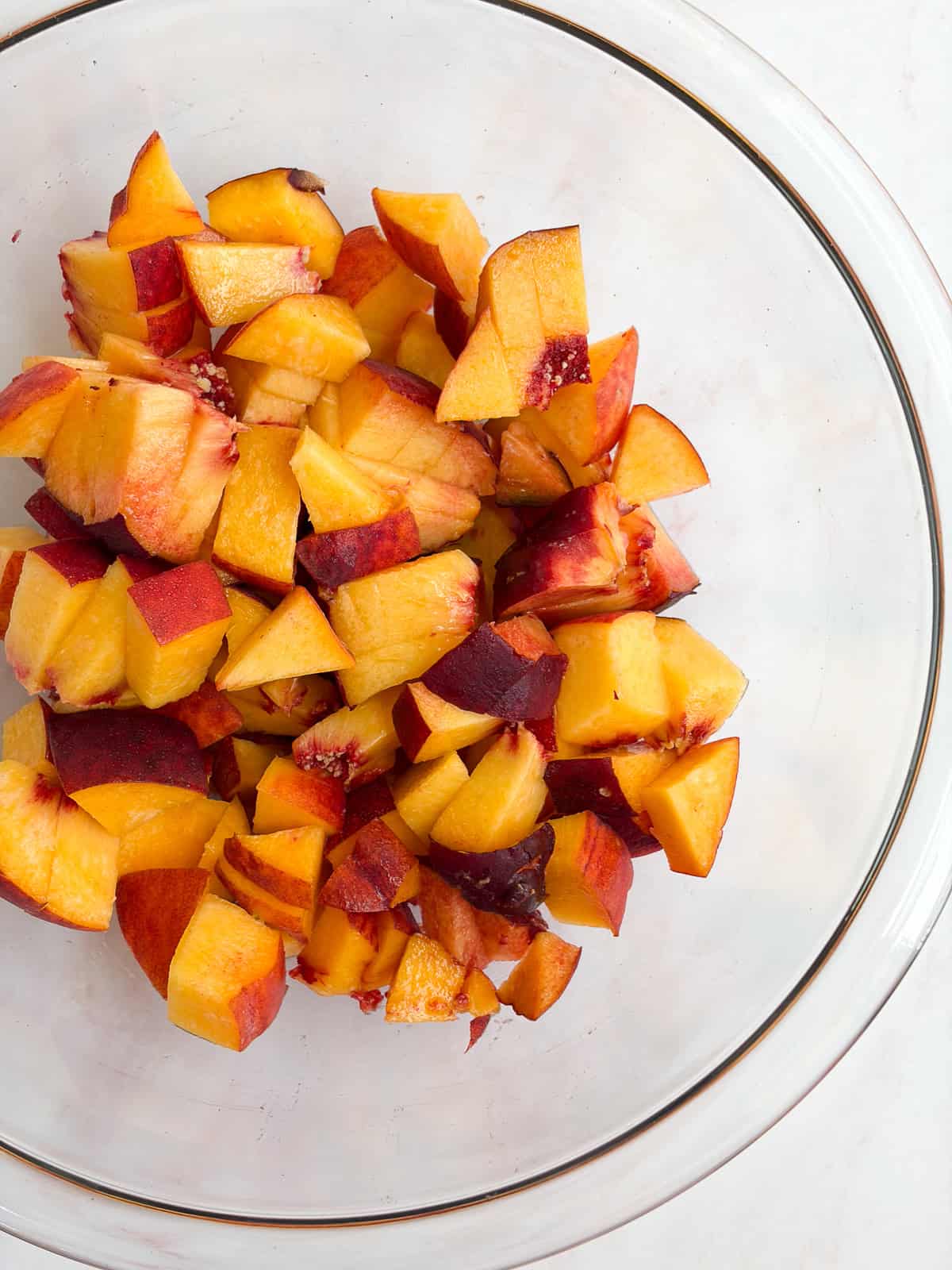a big bowl of peaches after they've been cut.