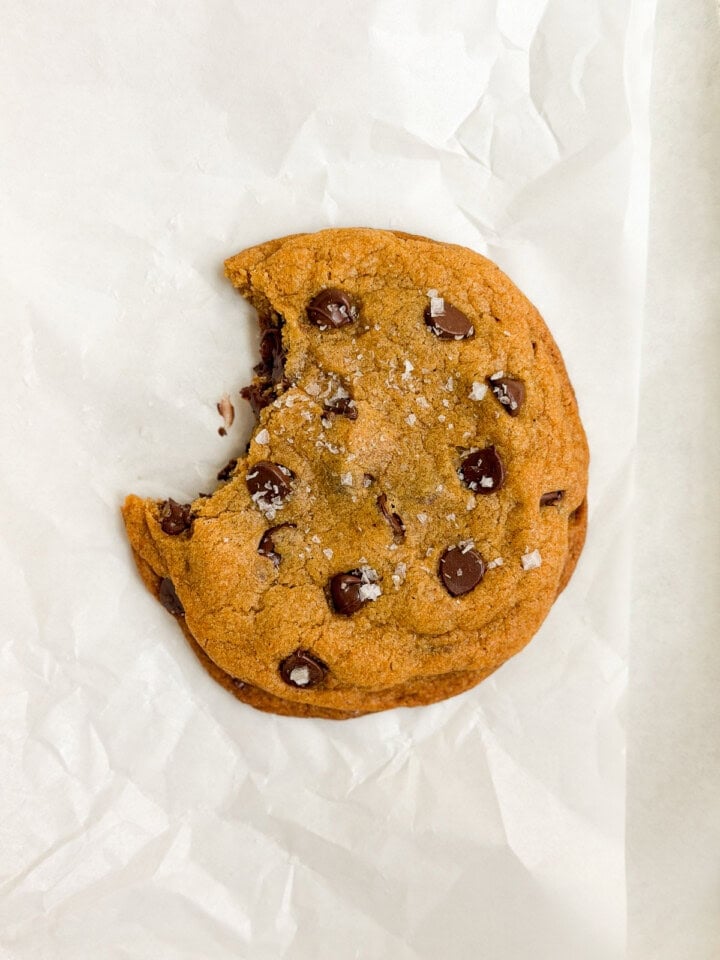 a single serve pumpkin cookie with a bite missing.
