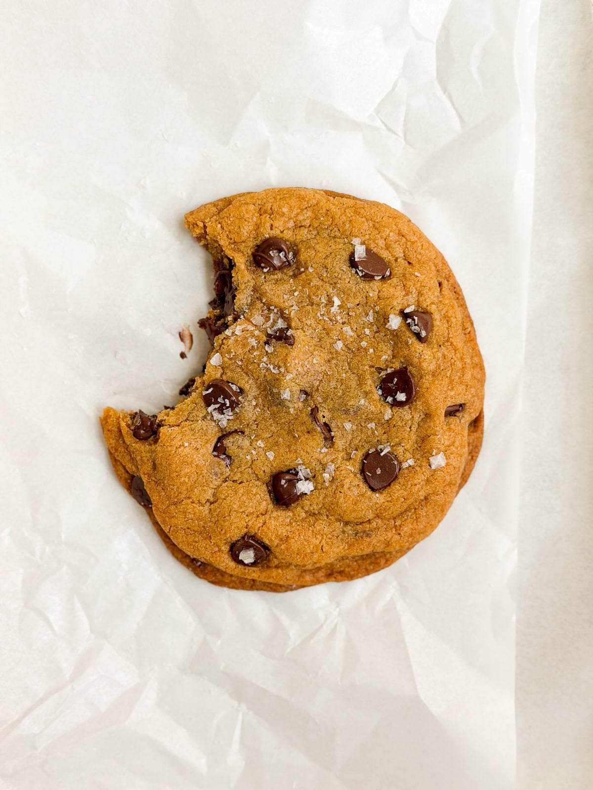 a single serve pumpkin cookie with a bite missing.