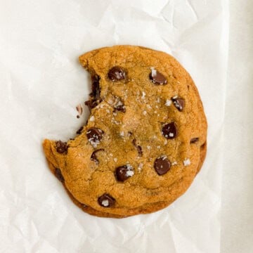 a single serve pumpkin cookie with a bite missing.