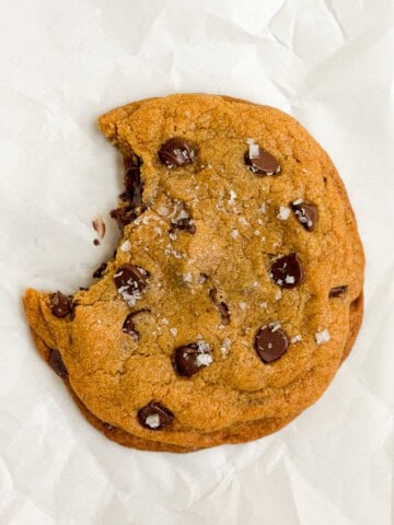 a single serve pumpkin cookie with a bite missing.