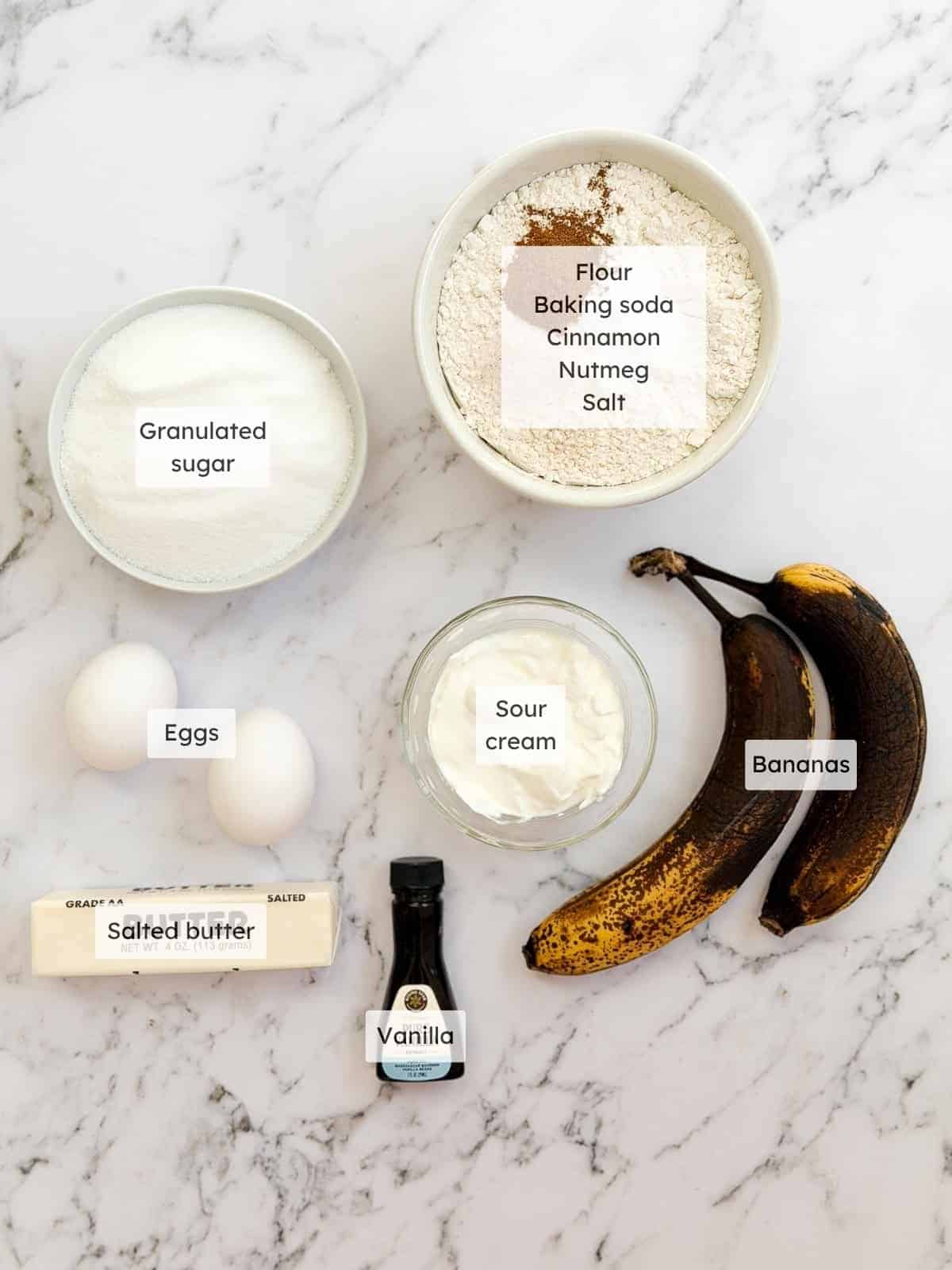 All of the ingredients needed to make sour cream banana bread.