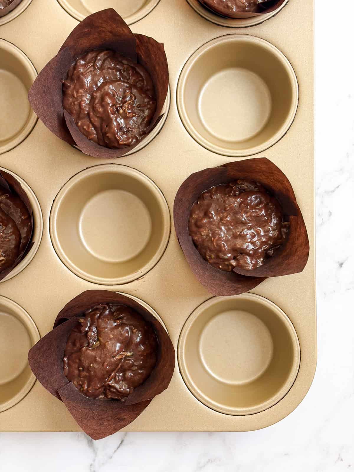 muffins in the muffin tin before baking.
