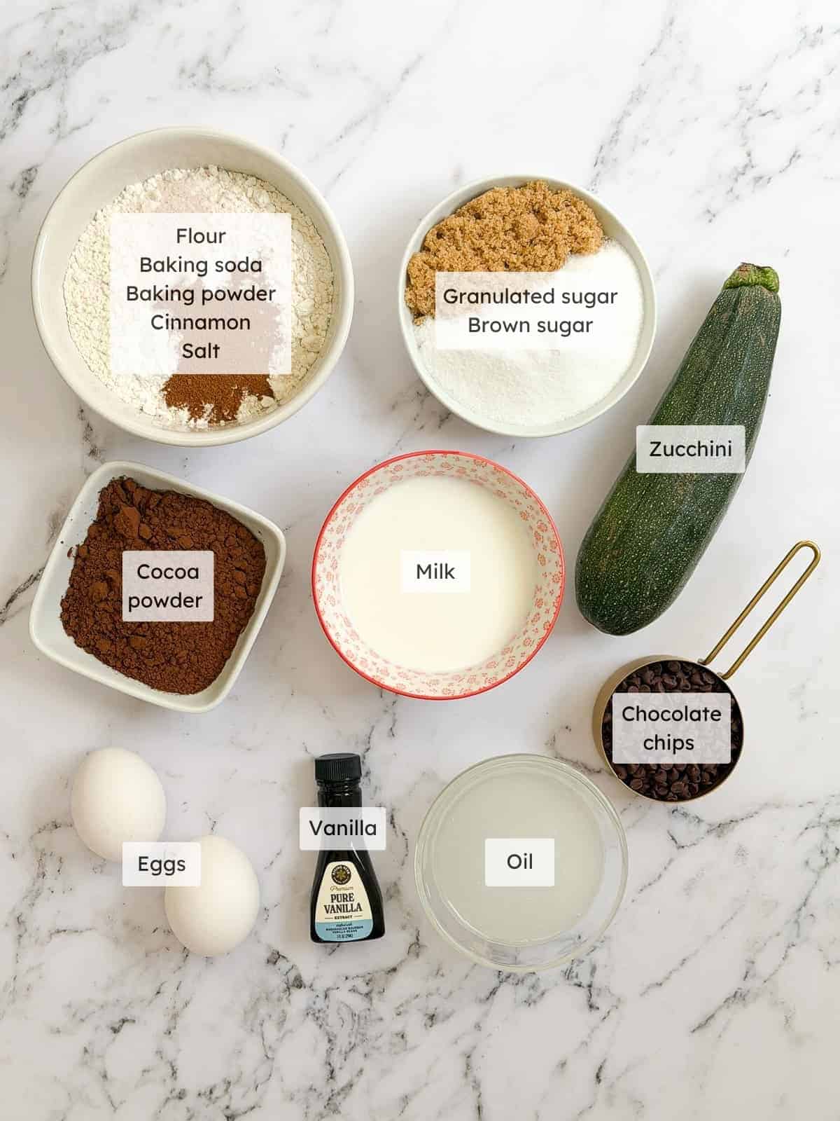 All of the ingredients needed to make double chocolate zucchini muffins.