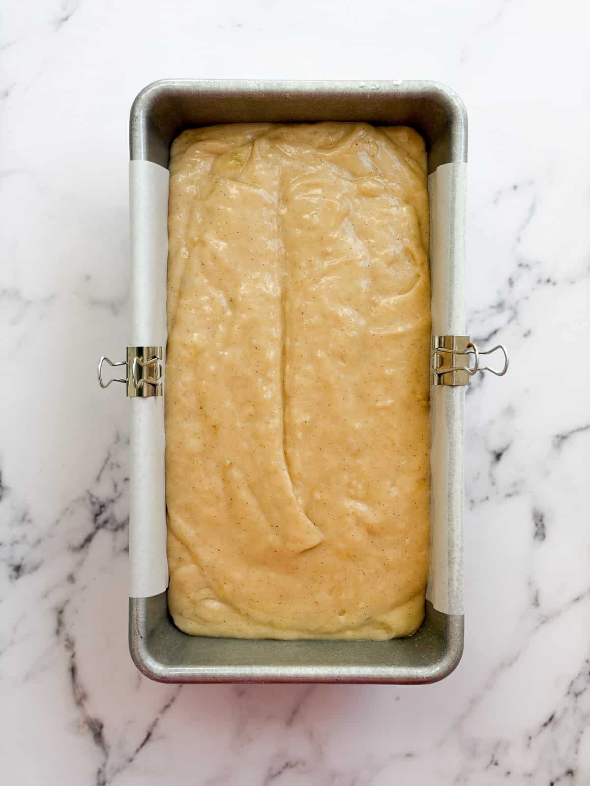 banana bread batter in the loaf pan before baking.