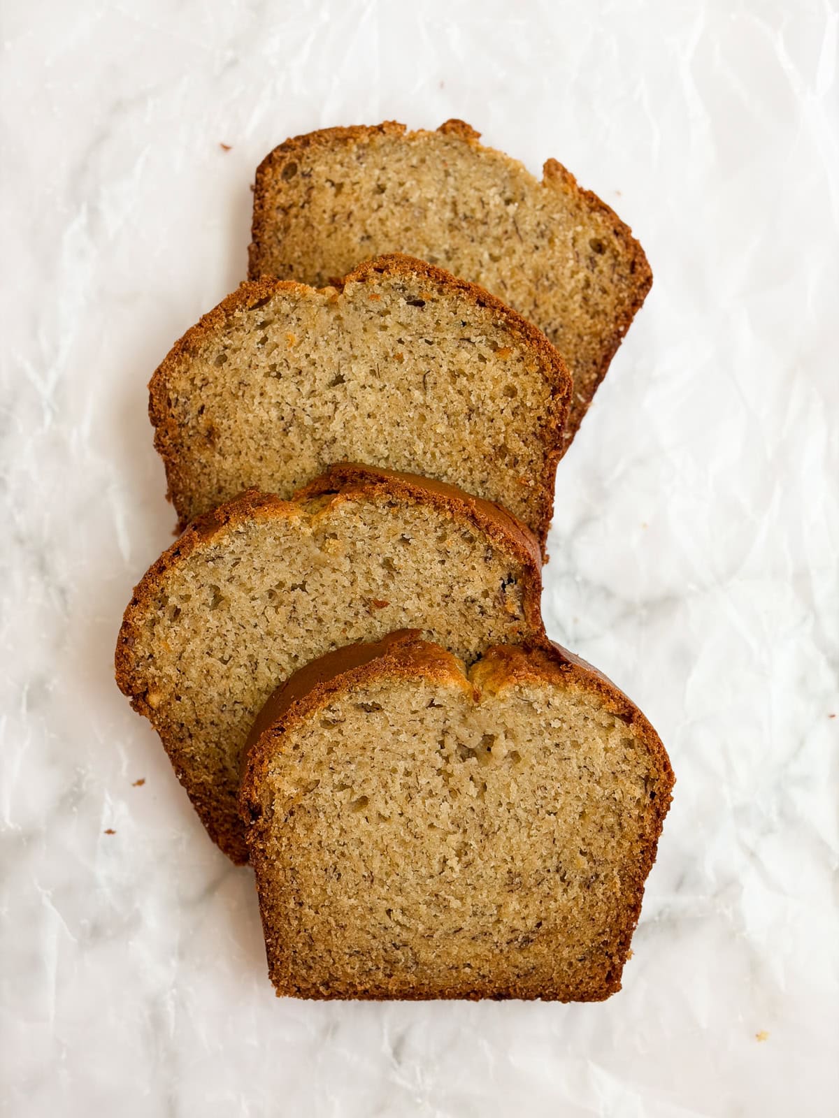 4 slices of sour cream banana bread stacked up.