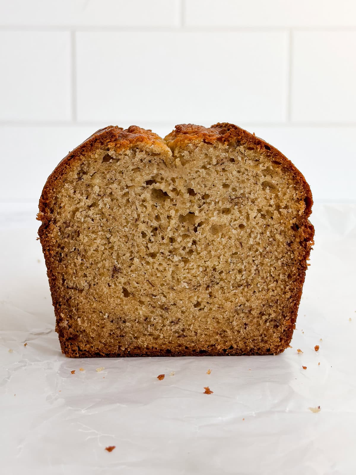 the sour cream banana bread loaf standing up so you can see the inside texture and how tall it is.
