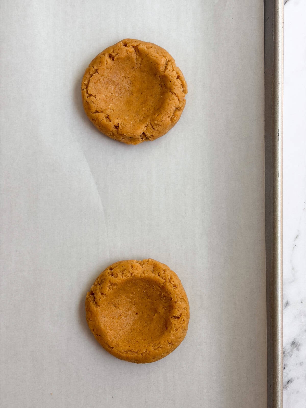cookie dough balls with the indentions made.